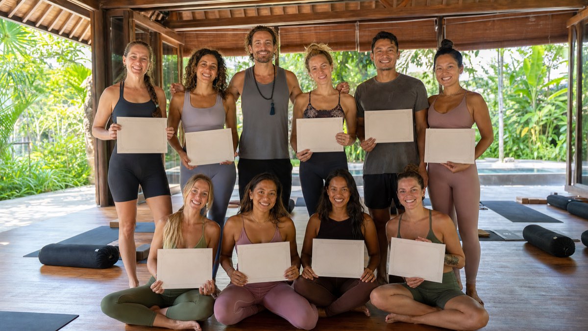 YogaFX hot yoga teacher training graduates celebrate with certificates after completing practical Original Hot 26&2 study in Bali
