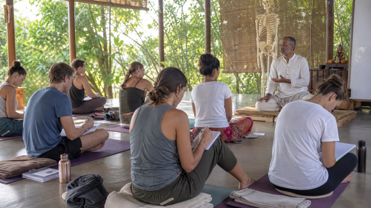 Students attending a traditional yoga teacher training program in India