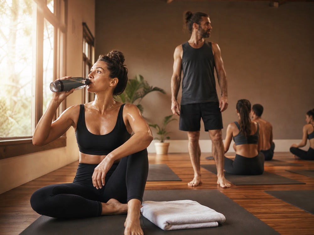 Heat yoga hydration and safety Heat yoga student taking a safe hydration break